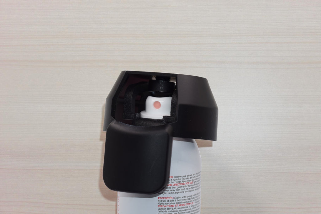Black Spray Doctor mounted on a spray can in closed position, front perspective view
