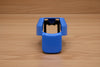 Blue ergonomic spray can adapter, Spray Doctor, on a wooden surface - front perspective view.
